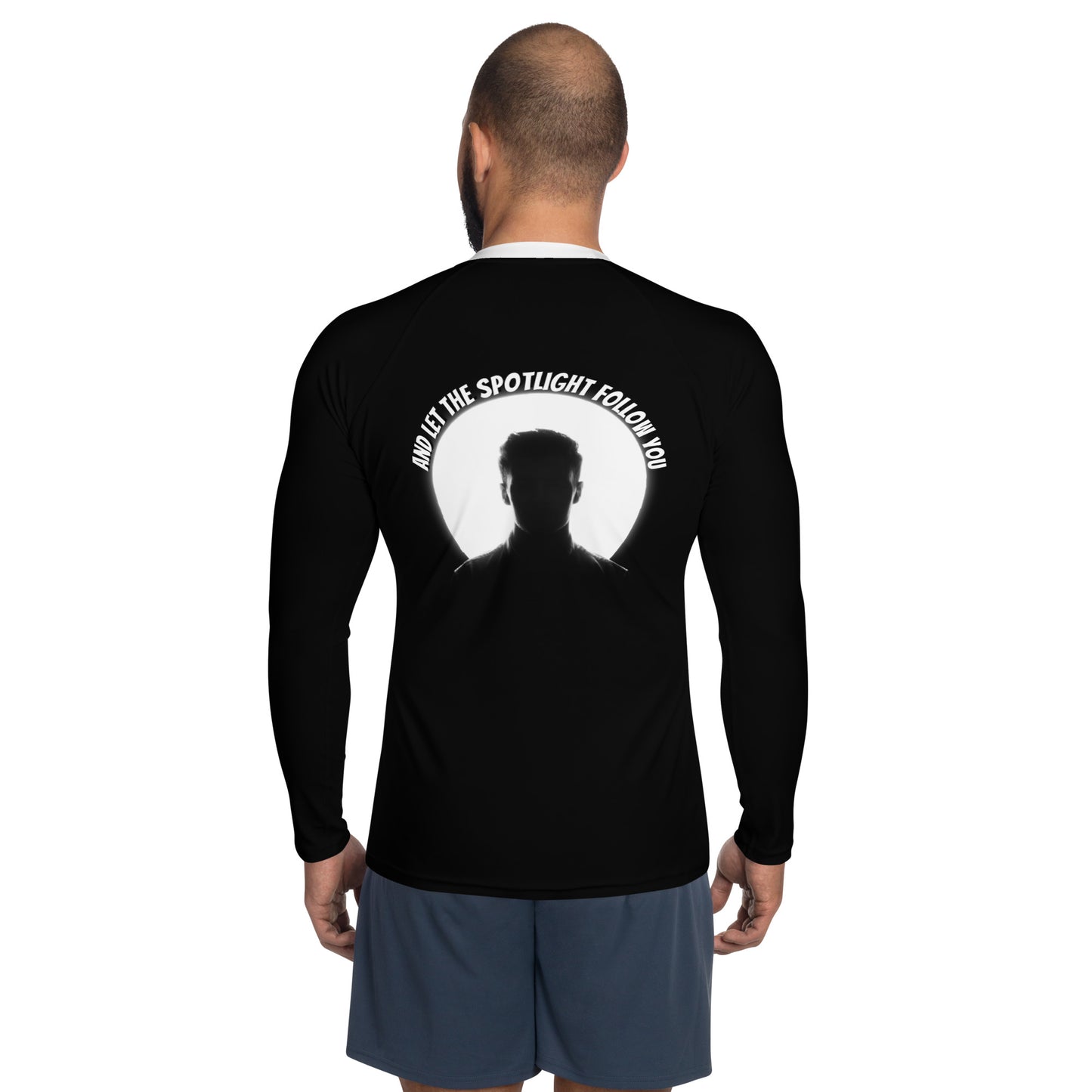 A confident man wearing the LBS Motivate Merch Men's Rash Guard, ready to lead with his best self and set goals for success