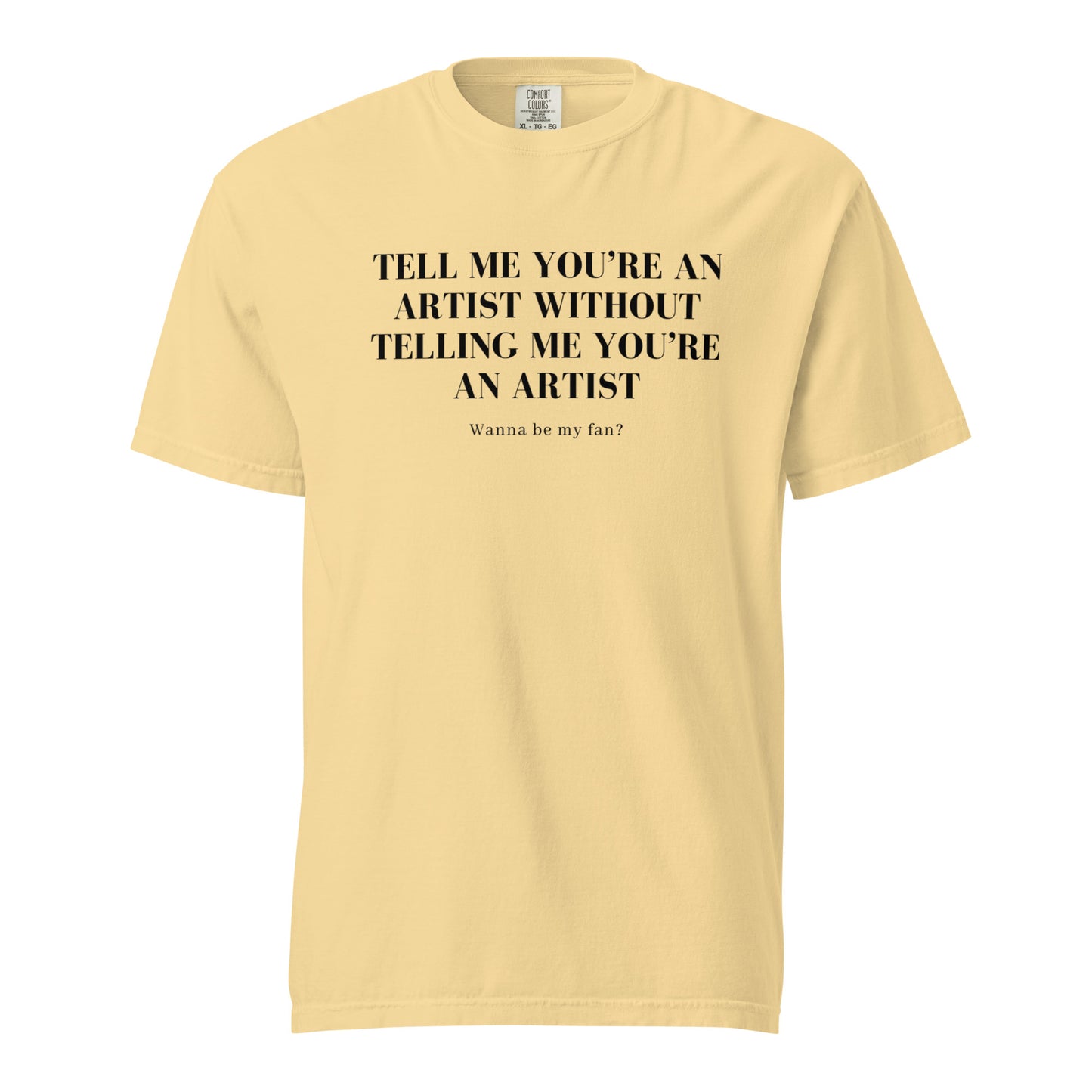 Image of the new meme tee from the Let 'Em Know Collection, featuring bold text that reads: 'Tell me you're an artist without telling me you're an artist. Wanna be my fan?' Plus, choose between plain and SpotlYght Seeker tags!