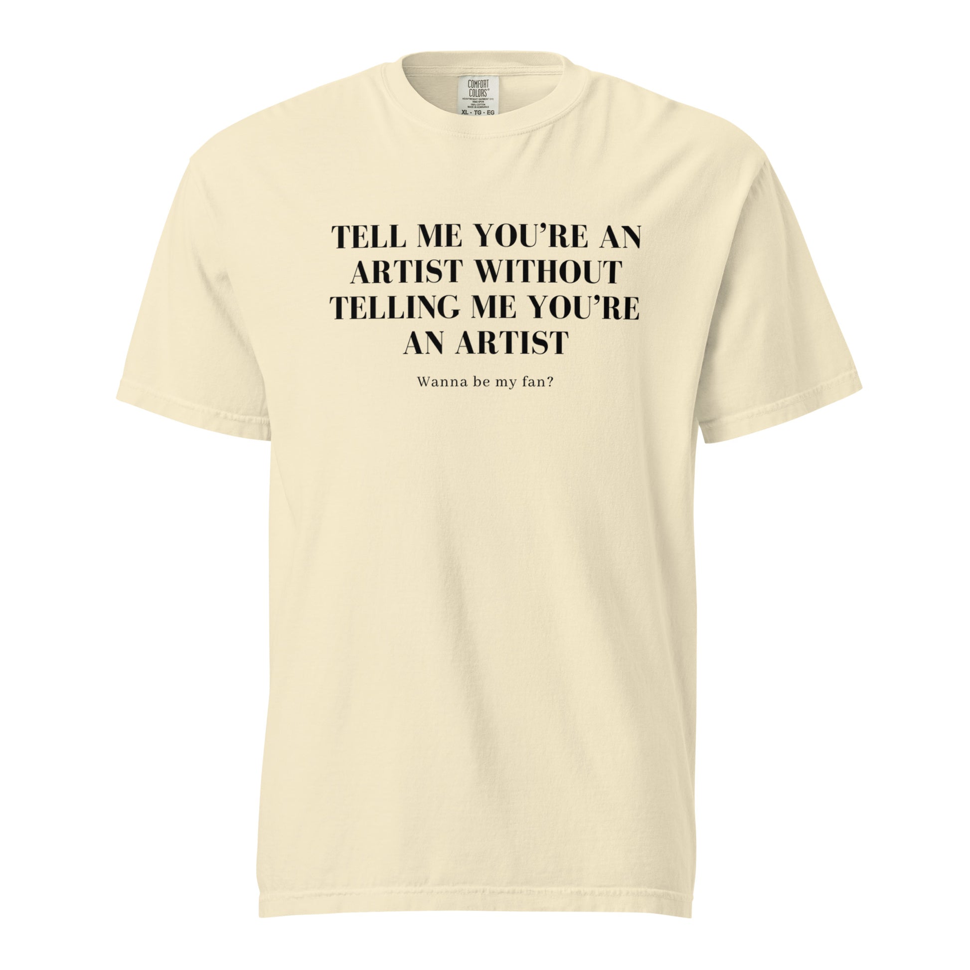 Image of the new meme tee from the Let 'Em Know Collection, featuring bold text that reads: 'Tell me you're an artist without telling me you're an artist. Wanna be my fan?' Plus, choose between plain and SpotlYght Seeker tags!