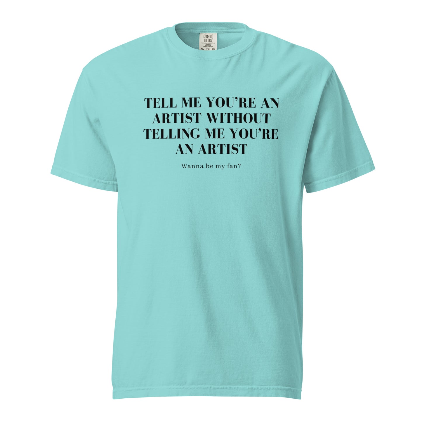 Image of the new meme tee from the Let 'Em Know Collection, featuring bold text that reads: 'Tell me you're an artist without telling me you're an artist. Wanna be my fan?' Plus, choose between plain and SpotlYght Seeker tags!