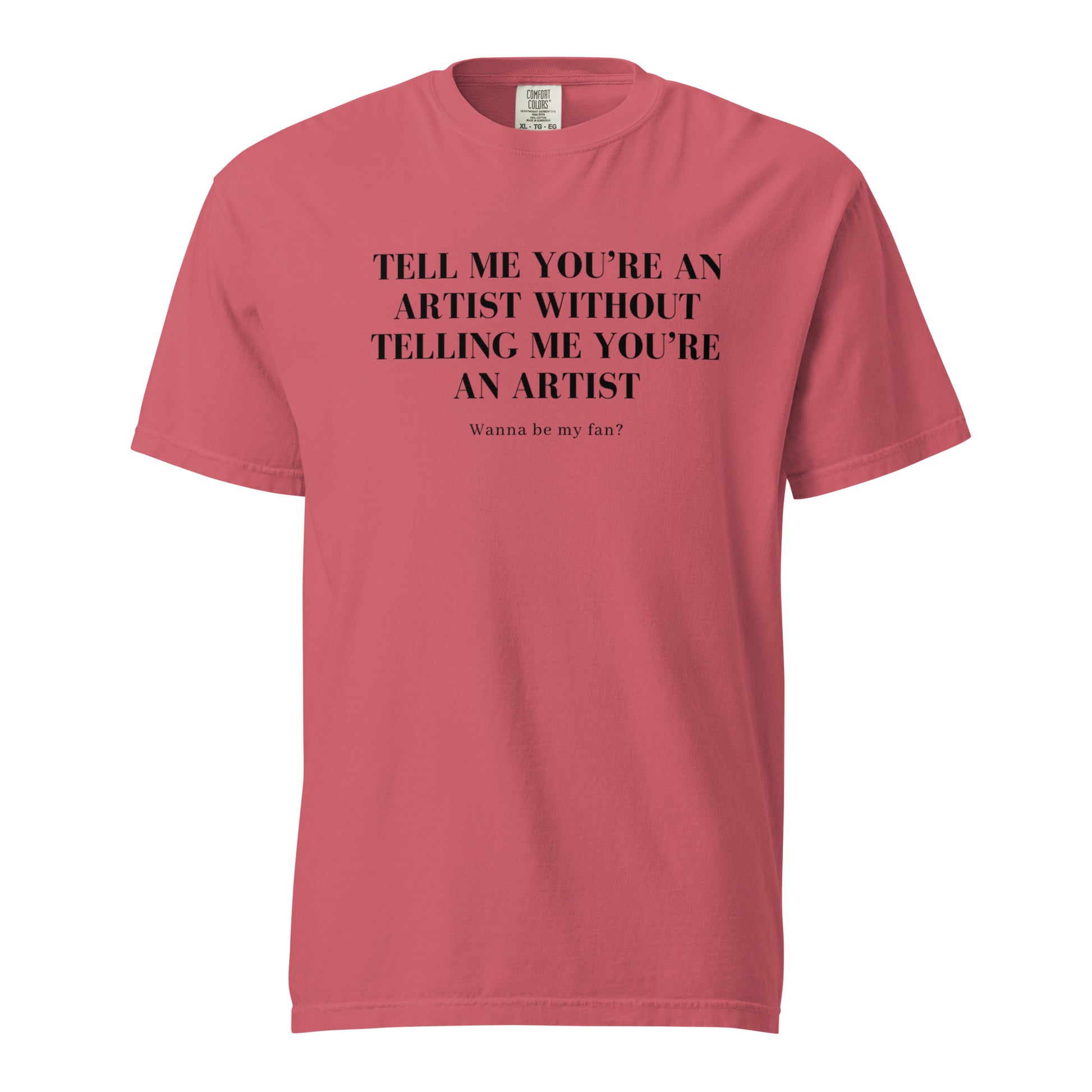 Image of the new meme tee from the Let 'Em Know Collection, featuring bold text that reads: 'Tell me you're an artist without telling me you're an artist. Wanna be my fan?' Plus, choose between plain and SpotlYght Seeker tags!