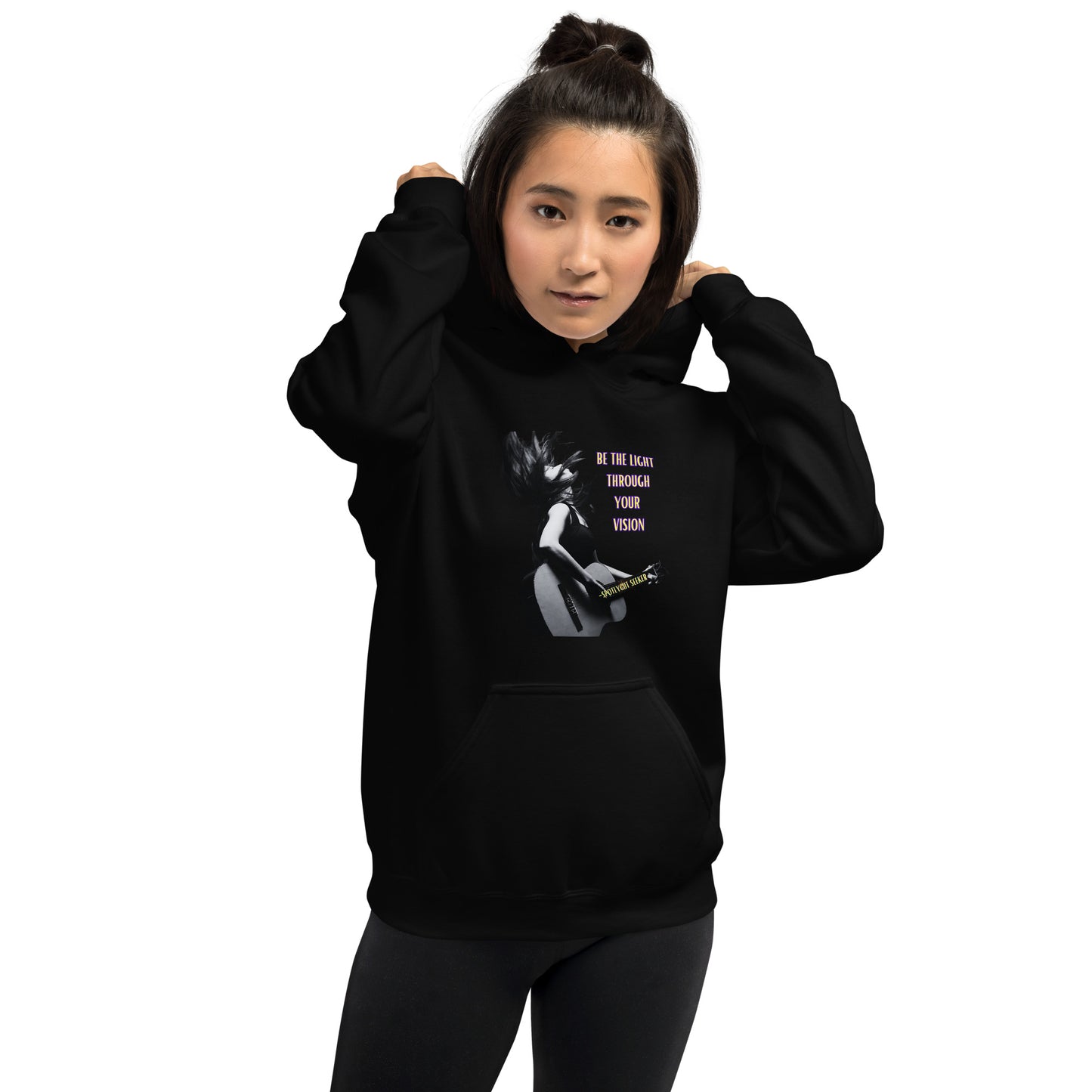 A stylish black and white Heavyweight Be the Light Unisex Hoodie displayed against a backdrop of creativity. The bold graphics symbolize authenticity, inviting artists to embrace their vision and be the light for their audience.